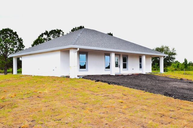 15722 NW 270th St, Okeechobee, FL 34972 - view of front of house featuring stucco siding, a shingled roof, and a front lawn