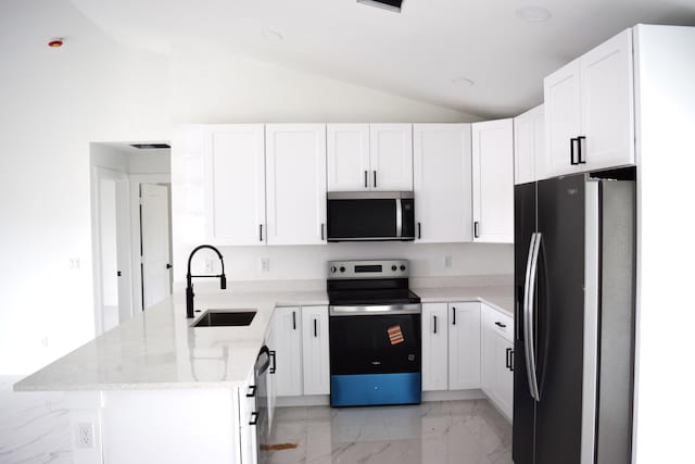 15722 NW 270th St, Okeechobee, FL 34972 - kitchen featuring stainless steel appliances, lofted ceiling, a sink, a peninsula, and light marble finish floors