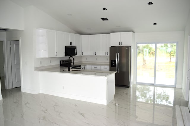 15722 NW 270th St, Okeechobee, FL 34972 - kitchen with stainless steel appliances, light countertops, a peninsula, vaulted ceiling, and light marble finish floors