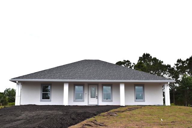 15722 NW 270th St, Okeechobee, FL 34972 - view of front of house featuring stucco siding, a shingled roof, a porch, and a front lawn