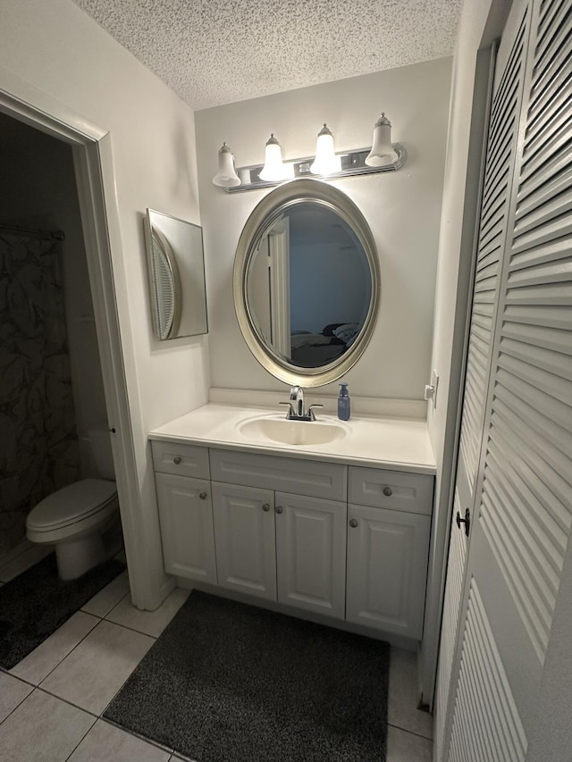 933 Savannas Point Dr Unit C, Fort Pierce, FL 34982 - full bathroom with tile patterned floors, vanity, a closet, toilet, and a textured ceiling