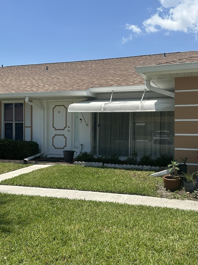 933 Savannas Point Dr Unit C, Fort Pierce, FL 34982 - entrance to property with a lawn and roof with shingles