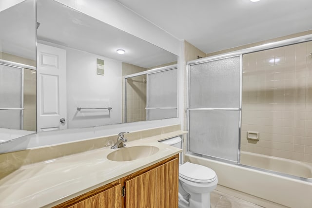 full bathroom featuring toilet, combined bath / shower with glass door, tile patterned floors, visible vents, and vanity