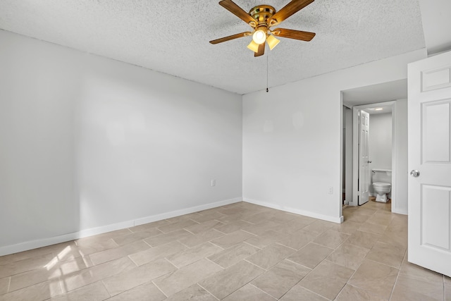 unfurnished bedroom with ceiling fan, a textured ceiling, light tile patterned flooring, and baseboards