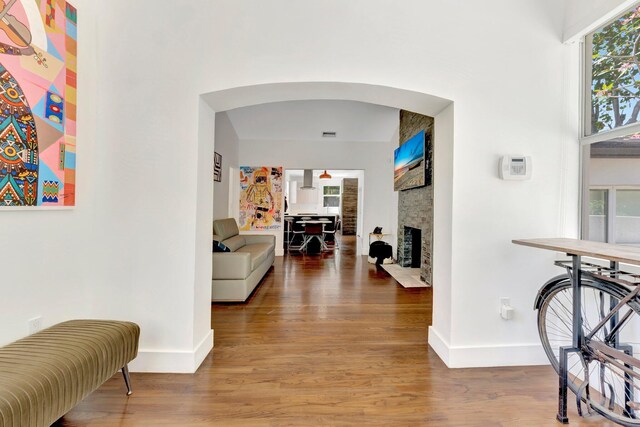 430 NE 121st St, Biscayne Park, FL 33161 - corridor with baseboards, arched walkways, and wood finished floors