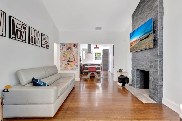 430 NE 121st St, Biscayne Park, FL 33161 - living room featuring baseboards, a stone fireplace, visible vents, and wood finished floors