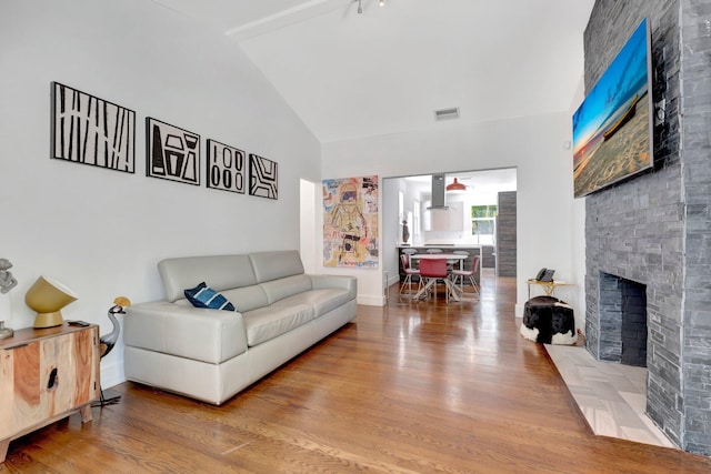 430 NE 121st St, Biscayne Park, FL 33161 - living area with a fireplace, high vaulted ceiling, visible vents, and wood finished floors