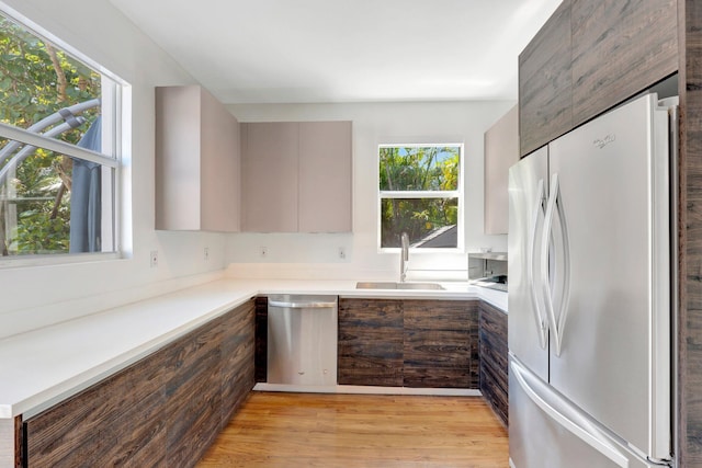 430 NE 121st St, Biscayne Park, FL 33161 - kitchen with a sink, light wood finished floors, light countertops, modern cabinets, and appliances with stainless steel finishes
