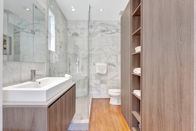 430 NE 121st St, Biscayne Park, FL 33161 - bathroom with toilet, tile walls, wood finished floors, vanity, and a marble finish shower