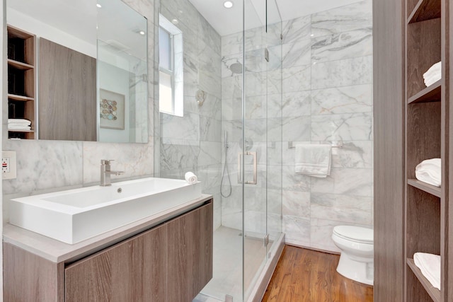 430 NE 121st St, Biscayne Park, FL 33161 - full bath featuring tile walls, toilet, a shower stall, vanity, and wood finished floors