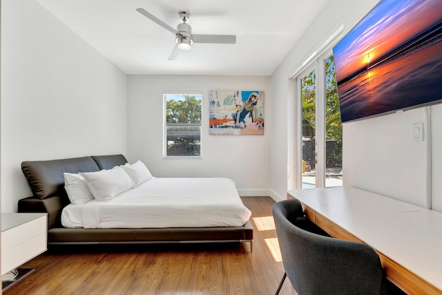 430 NE 121st St, Biscayne Park, FL 33161 - bedroom with baseboards, access to exterior, a ceiling fan, and wood finished floors