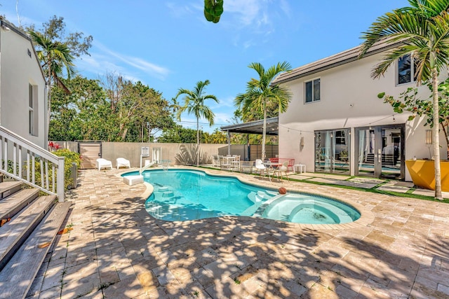 430 NE 121st St, Biscayne Park, FL 33161 - view of swimming pool with a patio, a pool with connected hot tub, and a fenced backyard