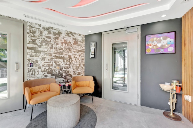 430 NE 121st St, Biscayne Park, FL 33161 - sitting room featuring a raised ceiling, a wealth of natural light, and concrete floors