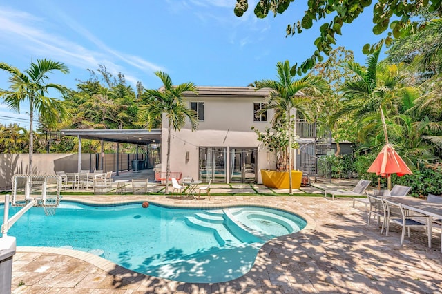 430 NE 121st St, Biscayne Park, FL 33161 - view of swimming pool with a pool with connected hot tub, fence, and a patio