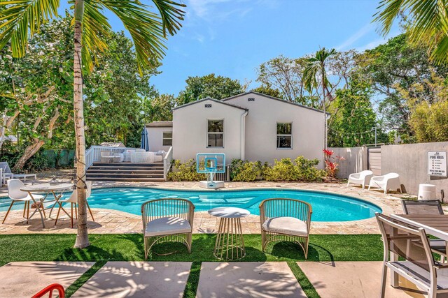 430 NE 121st St, Biscayne Park, FL 33161 - view of swimming pool featuring an outdoor hangout area, a patio, a fenced in pool, and fence