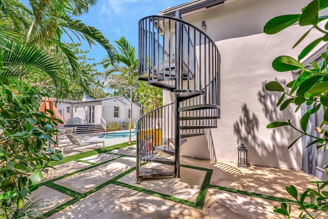 430 NE 121st St, Biscayne Park, FL 33161 - view of patio / terrace with stairway and an outdoor pool