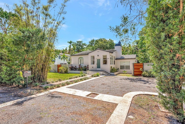 430 NE 121st St, Biscayne Park, FL 33161 - mediterranean / spanish-style house with stucco siding, a chimney, and fence