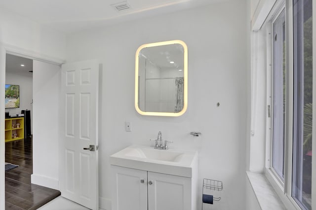 430 NE 121st St, Biscayne Park, FL 33161 - bathroom featuring vanity, baseboards, visible vents, and wood finished floors