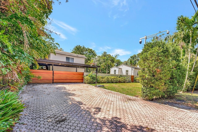 430 NE 121st St, Biscayne Park, FL 33161 - view of front of house featuring fence, stucco siding, and a front yard