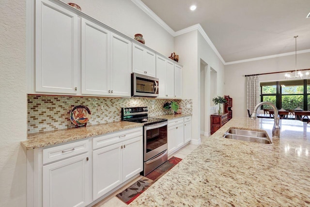 964 SW Canoe Creek Ter, Palm City, FL 34990 - kitchen featuring crown molding, appliances with stainless steel finishes, tasteful backsplash, and a sink
