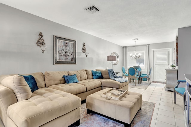 living area with a chandelier and light tile patterned floors