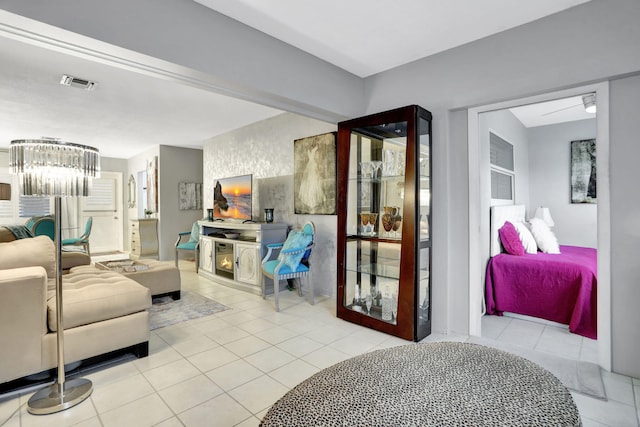 bedroom featuring tile patterned flooring and a chandelier