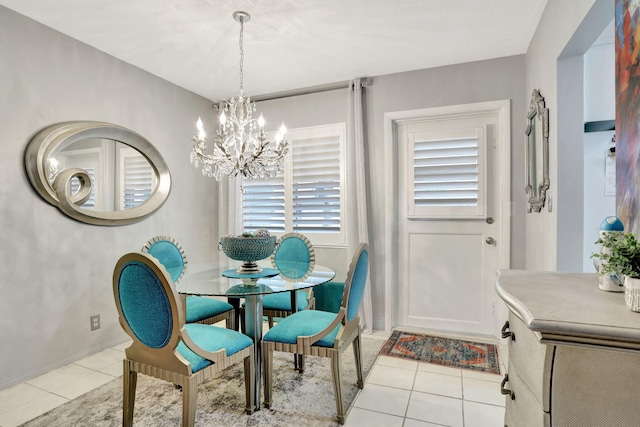 dining room featuring a chandelier, light tile patterned floors, and baseboards