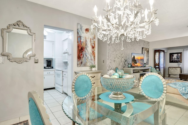 dining space with light tile patterned floors, a chandelier, and baseboards