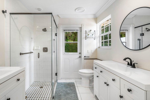 full bathroom featuring a stall shower, vanity, toilet, and crown molding