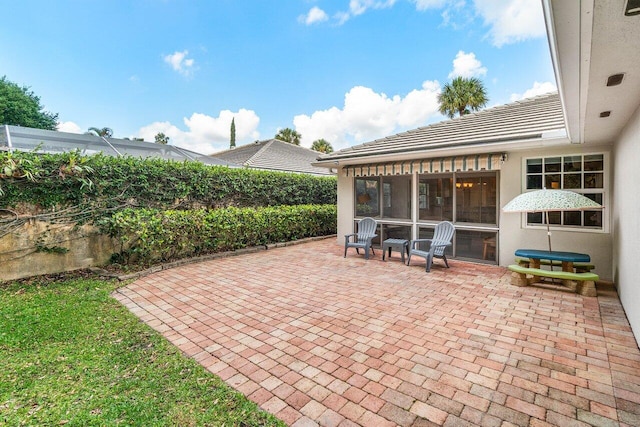 view of patio featuring a sunroom