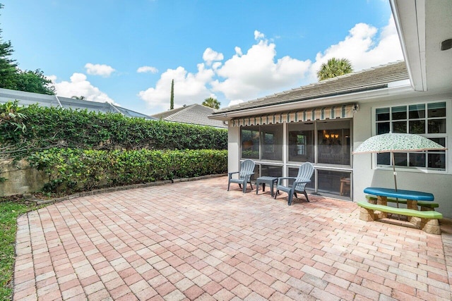 view of patio / terrace featuring a sunroom
