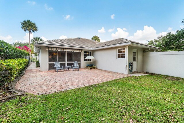 8334 Old Forest Rd, Palm Beach Gardens, FL 33410 - rear view of house featuring stucco siding, a patio, a tiled roof, and a sunroom