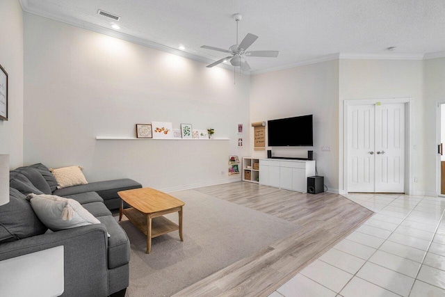 living area with visible vents, ceiling fan, light wood-style floors, ornamental molding, and recessed lighting