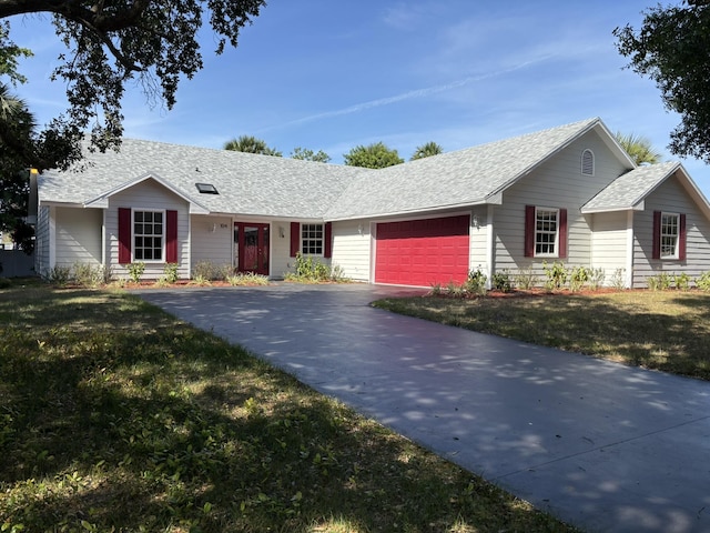 ranch-style home with a garage, a shingled roof, a front lawn, and driveway