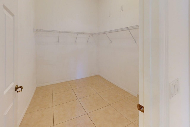 walk in closet featuring light tile patterned flooring