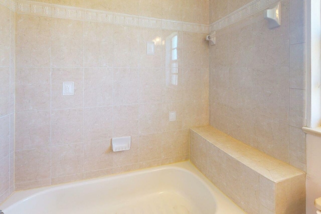 full bath featuring walk in shower and a tub