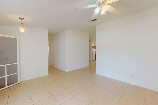 spare room featuring light tile patterned floors, ceiling fan, and visible vents