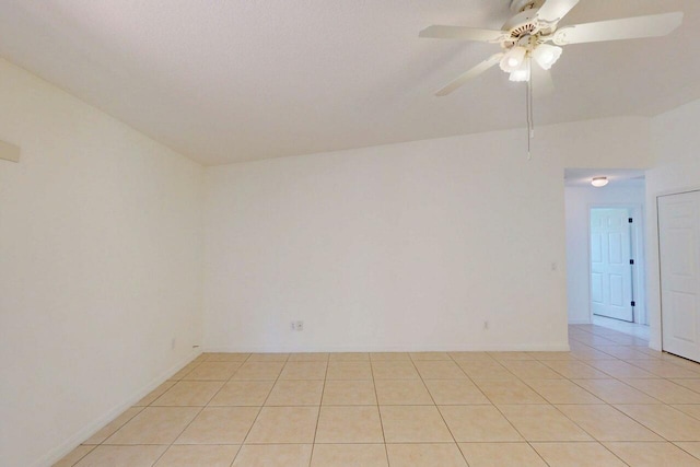 unfurnished room featuring light tile patterned flooring and a ceiling fan