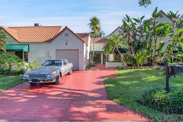 6560 Las Flores Dr, Boca Raton, FL 33433 - mediterranean / spanish-style house featuring decorative driveway, an attached garage, a tile roof, stucco siding, and a front lawn