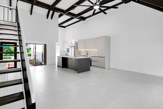 6560 Las Flores Dr, Boca Raton, FL 33433 - kitchen featuring a towering ceiling, open floor plan, light countertops, a kitchen island, and modern cabinets