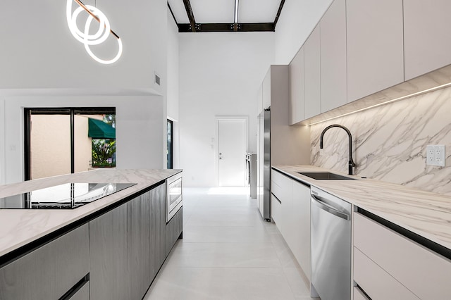6560 Las Flores Dr, Boca Raton, FL 33433 - kitchen with appliances with stainless steel finishes, a high ceiling, a sink, tasteful backsplash, and modern cabinets