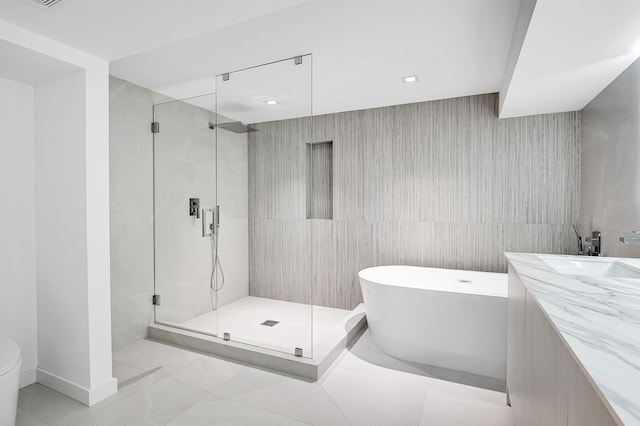 6560 Las Flores Dr, Boca Raton, FL 33433 - full bathroom with a stall shower, a soaking tub, tile walls, vanity, and toilet