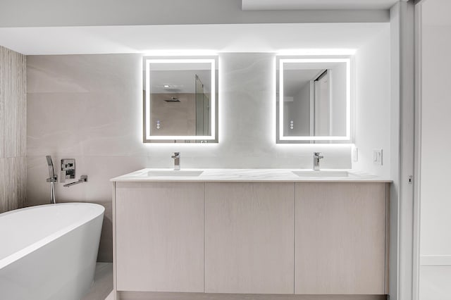 6560 Las Flores Dr, Boca Raton, FL 33433 - bathroom with tile walls, double vanity, a freestanding bath, and a shower