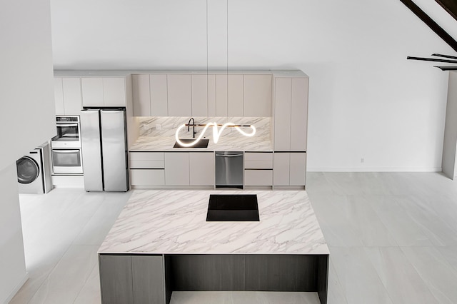 6560 Las Flores Dr, Boca Raton, FL 33433 - kitchen with stainless steel appliances, modern cabinets, washer / dryer, and light countertops