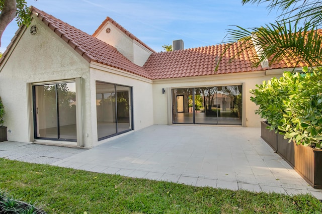 6560 Las Flores Dr, Boca Raton, FL 33433 - back of house with stucco siding, a patio, and a tiled roof