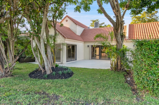 6560 Las Flores Dr, Boca Raton, FL 33433 - rear view of house with a tile roof, stucco siding, a patio area, and a yard
