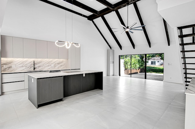 6560 Las Flores Dr, Boca Raton, FL 33433 - kitchen featuring high vaulted ceiling, modern cabinets, a sink, a center island, and open floor plan