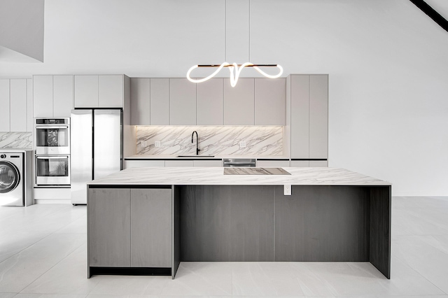 6560 Las Flores Dr, Boca Raton, FL 33433 - kitchen with washer / clothes dryer, appliances with stainless steel finishes, a sink, and modern cabinets