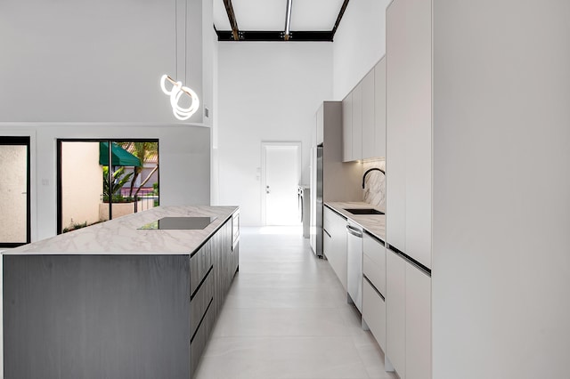 6560 Las Flores Dr, Boca Raton, FL 33433 - kitchen with modern cabinets, a high ceiling, a sink, a kitchen island, and white cabinetry