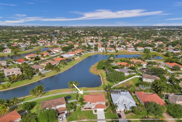 drone / aerial view featuring a water view and a residential view
